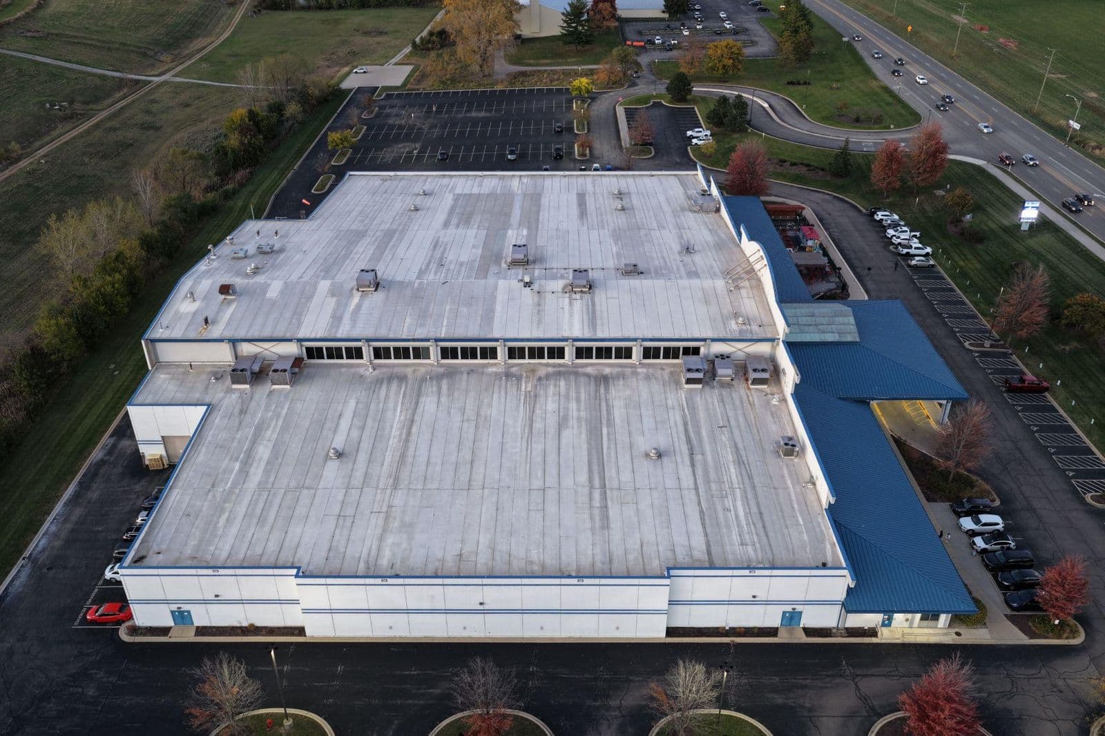 Aerial view of a commercial membrane roof and parking lot