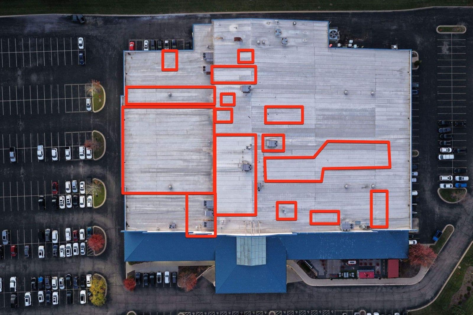 Aerial view of a commercial building roof and entrance canopy